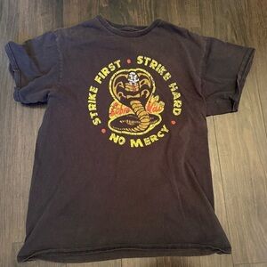 •COBRA KAI KARATE KID “STRIKE FIRST STRIKE HARD” UNISEX T-SHIRT
